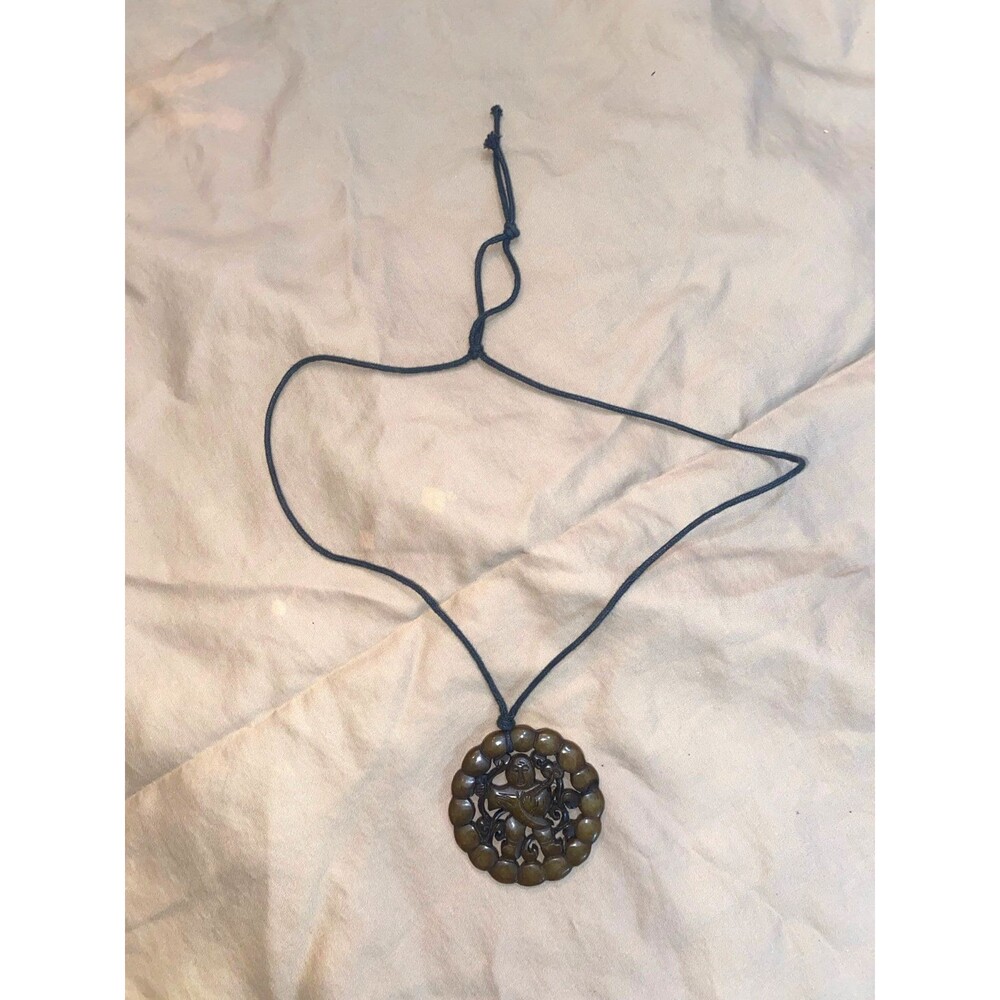 Hand‑Carved Round Pendant Necklace – Dark Stone Figure Design on Cord